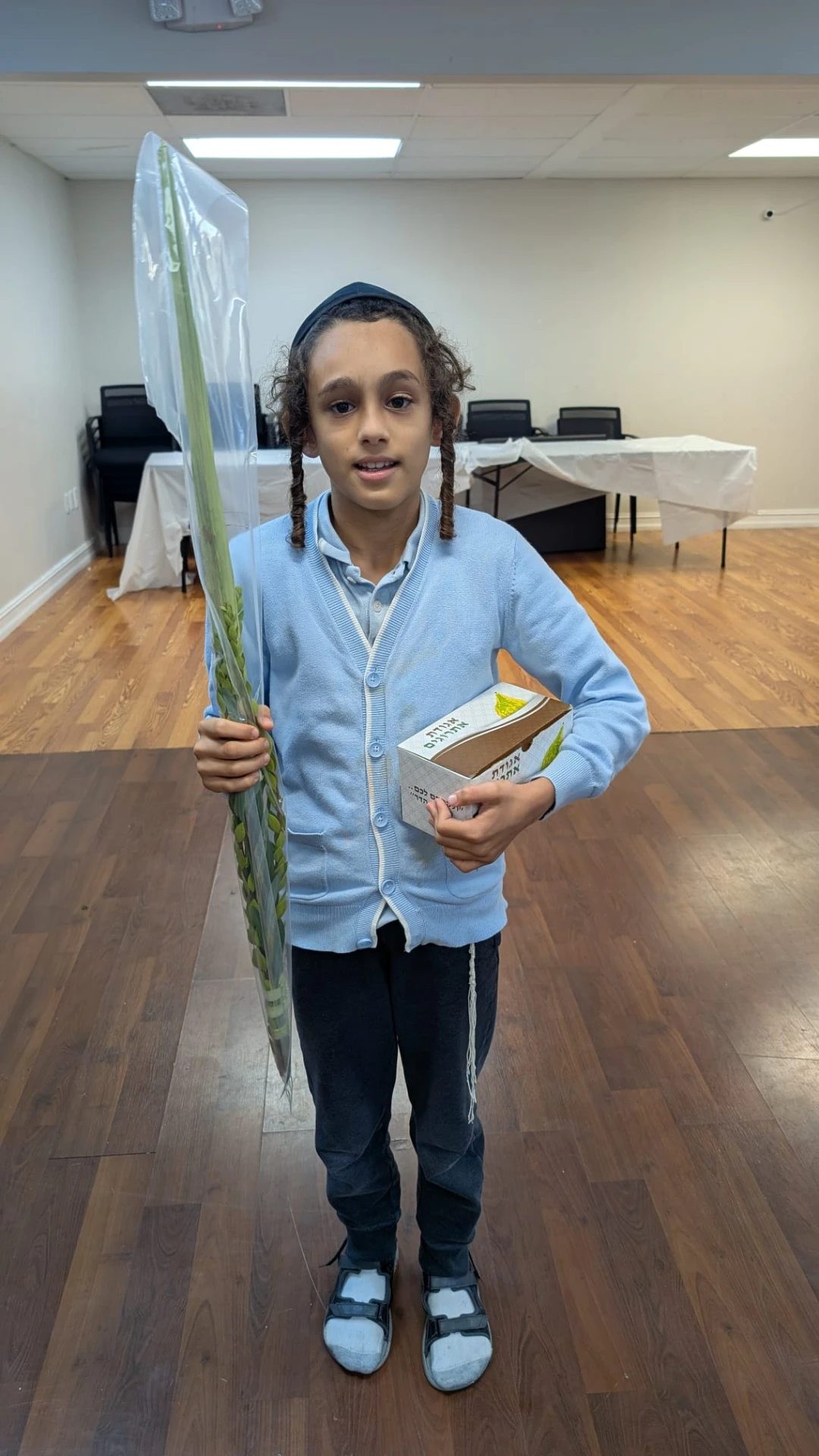 Talmid holding his lulav and esrog